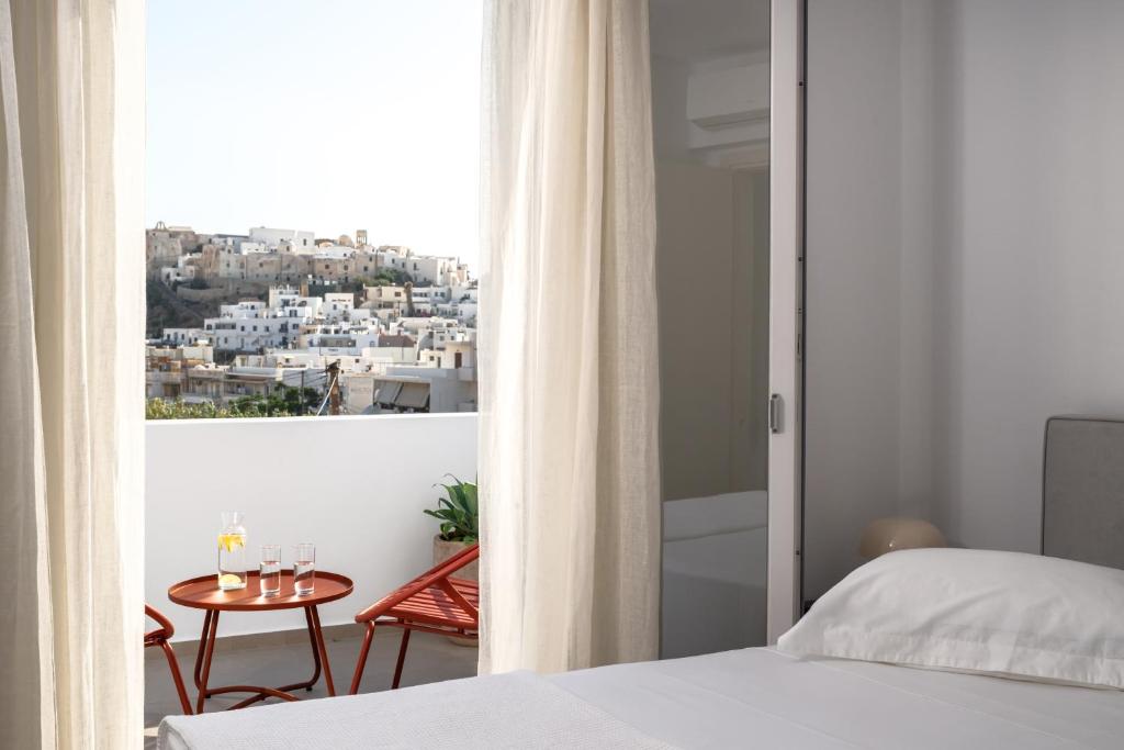 a bedroom with a bed and a view of a city at Estia Villas Naxos in Naxos Chora