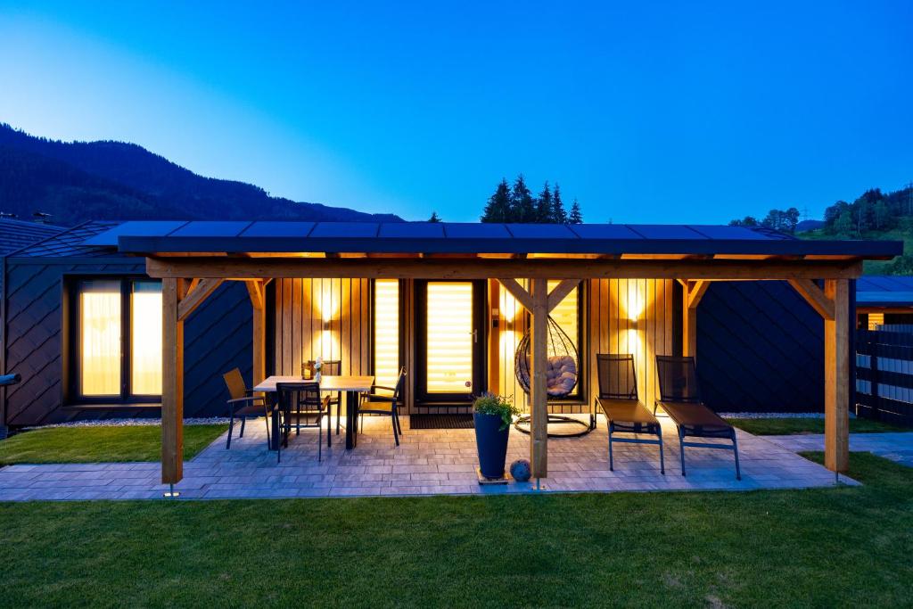 a pavilion with a table and chairs on a patio at Chalet Stuhleckblick Ferienhaus mit Sauna, Panorama und Terrasse in Spital am Semmering