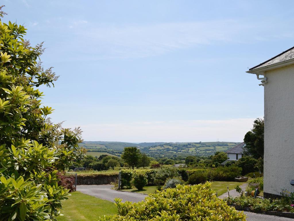 a view of a garden from a house at Beacon Cottage in Ivybridge