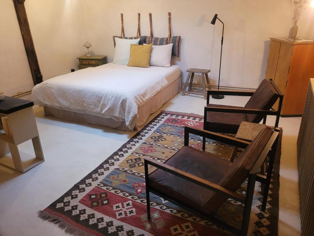a bedroom with a bed and a chair and a rug at Kranich in Ueckermünde