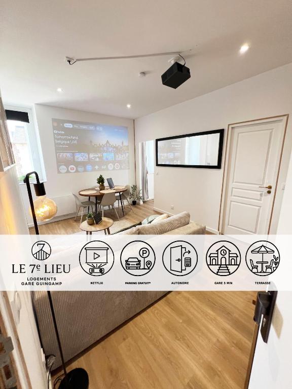 a large living room with a table and a table at Voyageur - Vidéoprojecteur - Terrasse - 5min gare in Ploumagoar