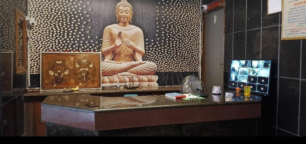 a large statue sitting on a counter in a museum at HoTEL SVR ELITE in Vijayawāda