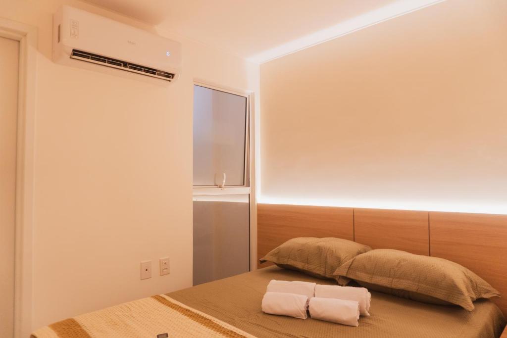 a bedroom with a bed with two towels on it at Apartamento Bitú in Fortaleza