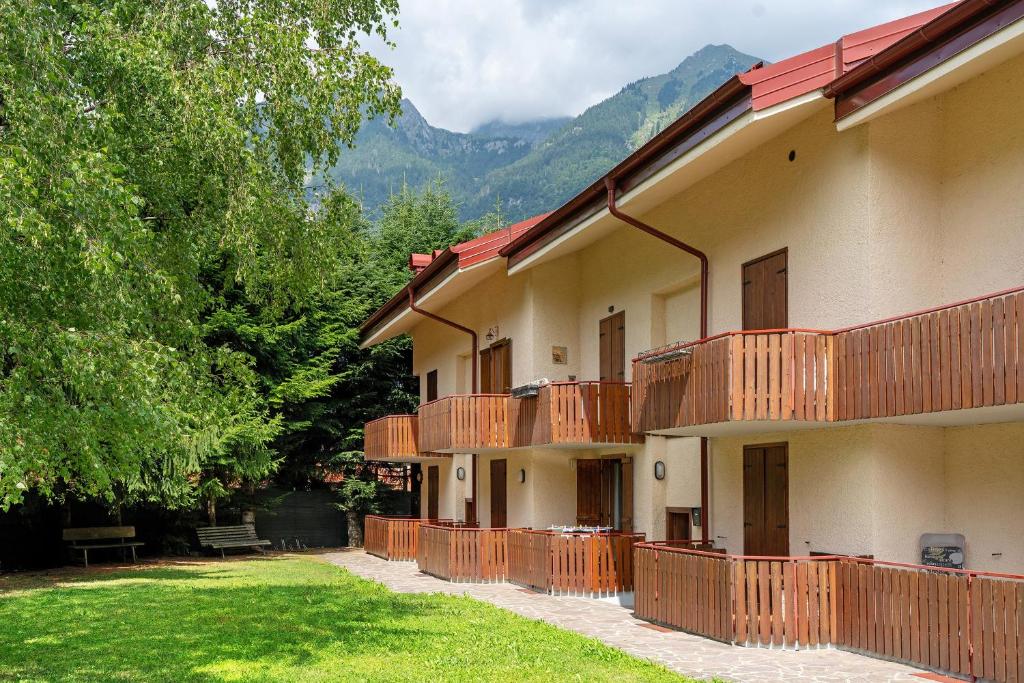 a building with balconies on the side of it at Dolomiti Apartment Pinzolo in Pinzolo