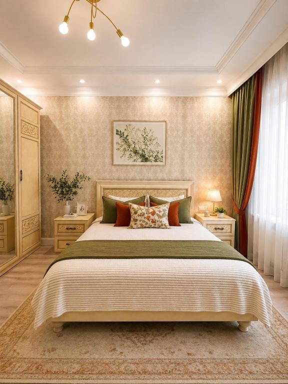 a bedroom with a large bed and two night stands at Luxe Apartments on Stepnoy in Karagandy