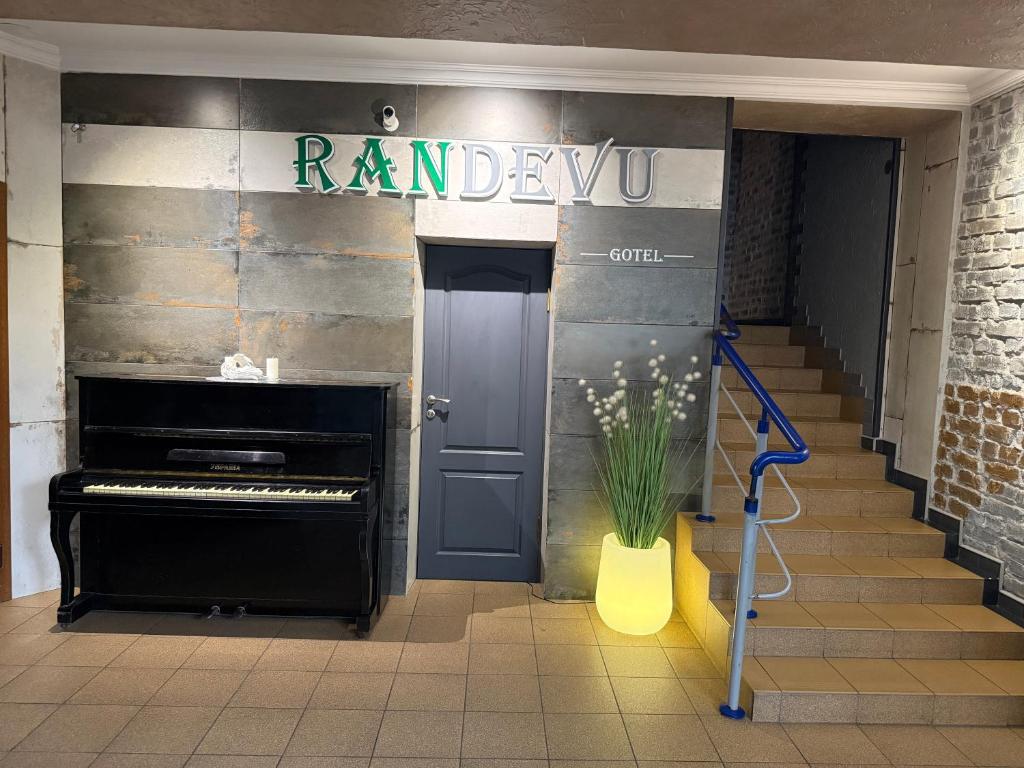 a hallway with a blue door and a piano at Міні-готель RANDEVU in Zhytomyr