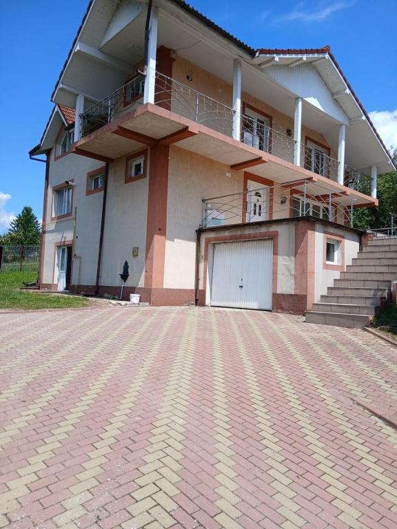 a house with a brick driveway in front of it at Vila Nana in Râmnicu Vâlcea