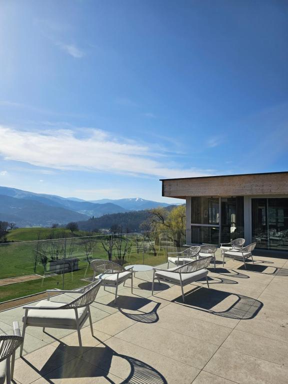 a group of benches sitting outside of a building at Domaine Le H in Munster