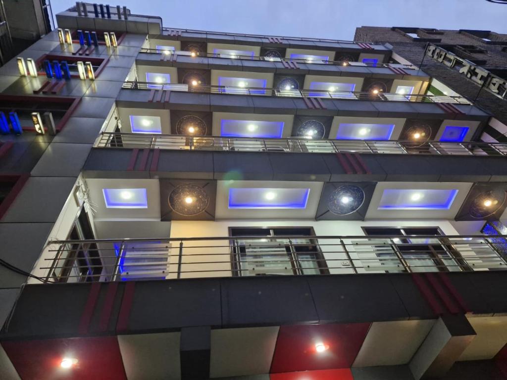 an external view of a building with blue lights at Abu Khalid By MZ Hotels & Restaurant in Mingāora