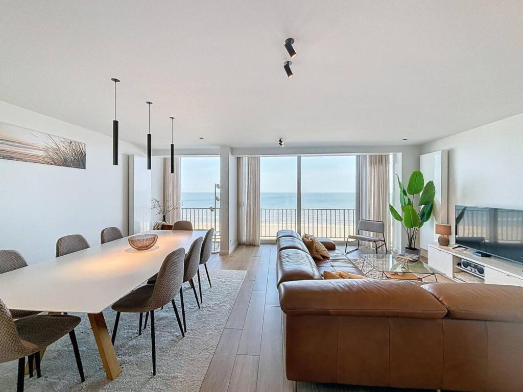 a living room with a couch and a table at Flat Sealodge - Koksijde in Sint-Idesbald