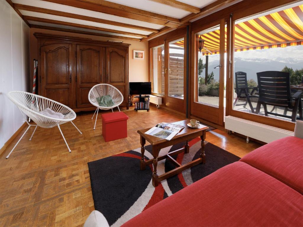 a living room with a couch and a table and chairs at Apartment Terrasse Des Alpes 708 by Interhome in Vermala