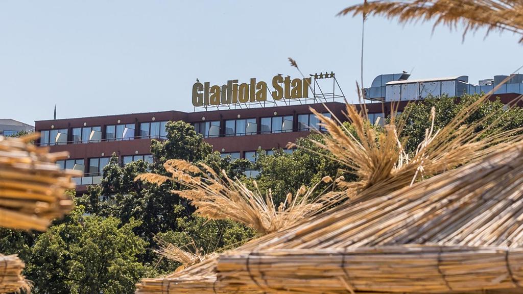 a building with a sign on top of it at Gladiola 4-star in Golden Sands