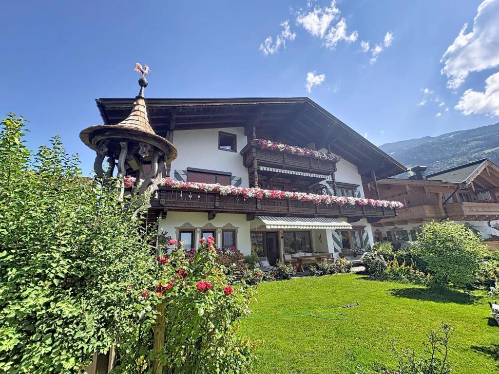 a house with flowers on the top of it at Apartment Tyrol-1 by Interhome in Aschau