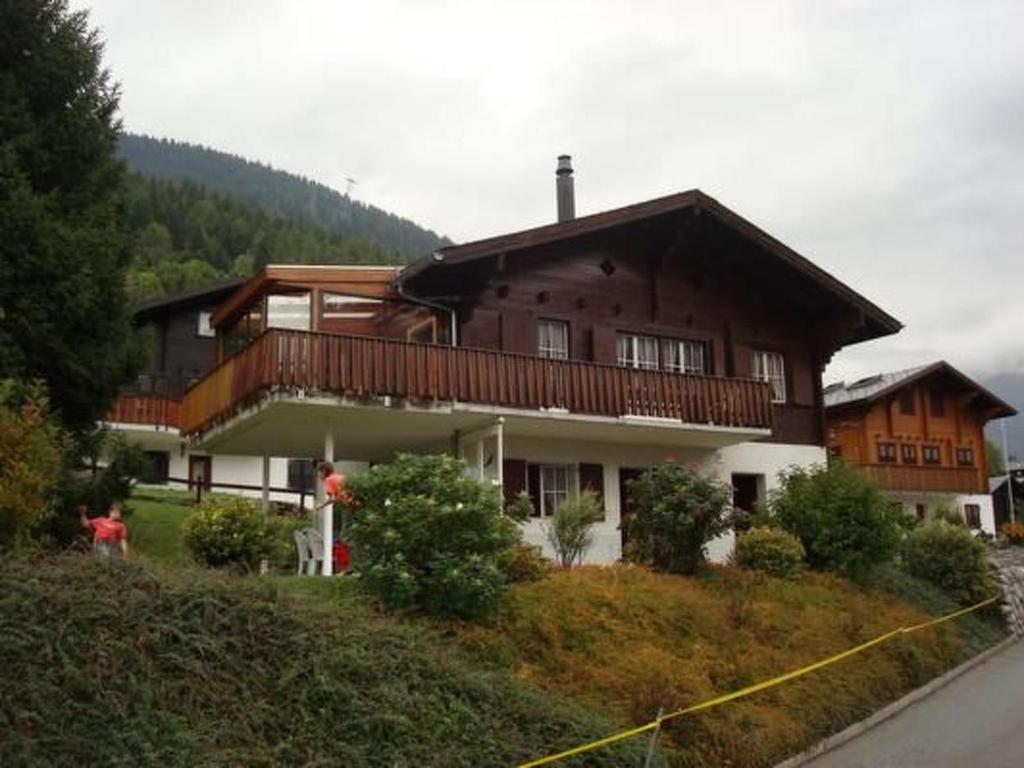 a large house sitting on top of a hill at Apartment Chalet Bärli by Interhome in Fiesch