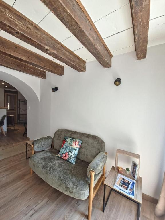 a living room with a couch and a table at La Voûte - Clim et Gare 5 min in Rumilly