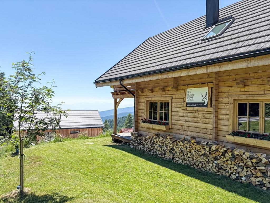 a log cabin with a tree in front of it at Chalet Chalet Amsel by Interhome in Hochrindl