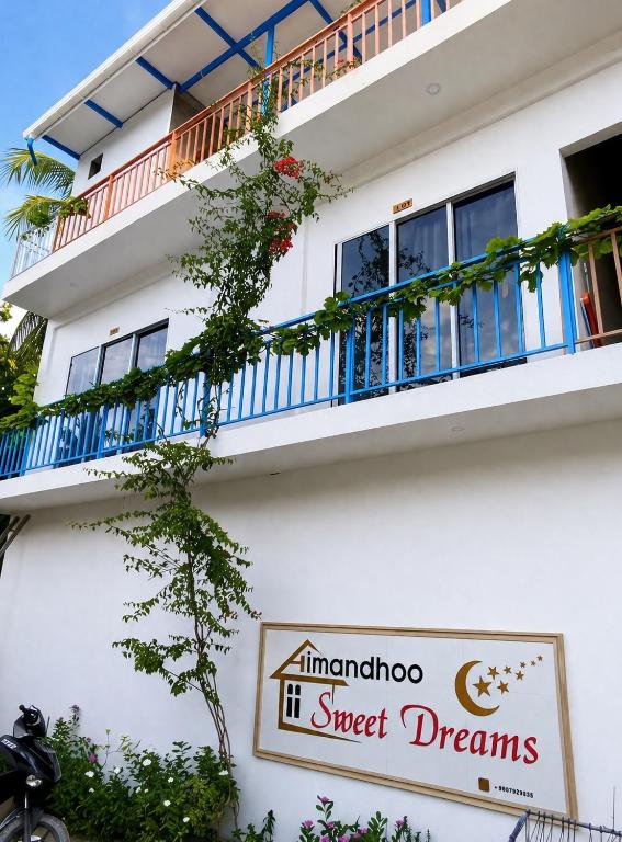 a building with a sign on the side of it at Island Hospitality in Himandhoo 