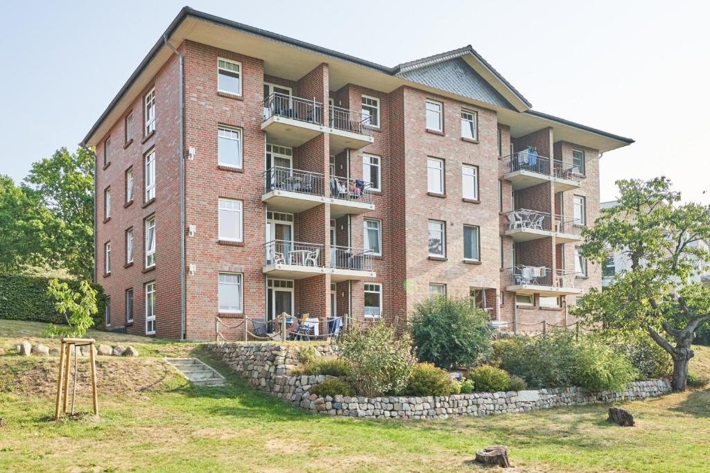 a large brick building with balconies on it at Haus Roland, Wohnung 16 in Zinnowitz