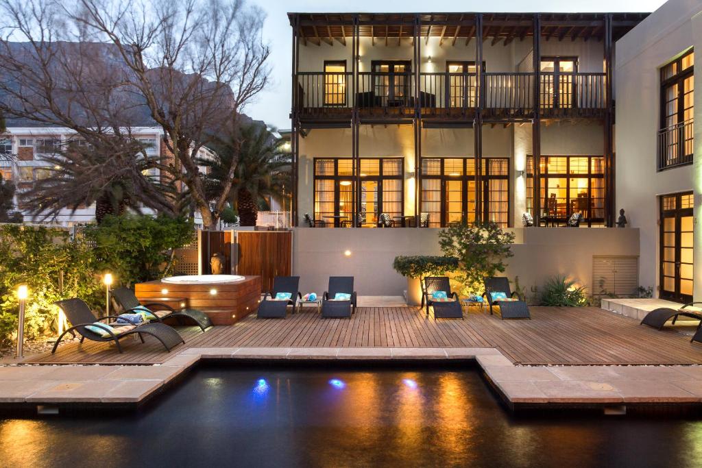 a house with a swimming pool in front of a building at Derwent House in Cape Town