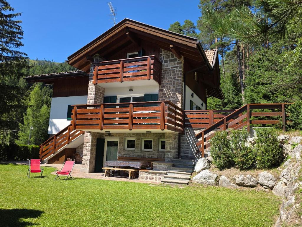 a large house with a balcony on top of it at Chalet Villa Bianca in Tesero