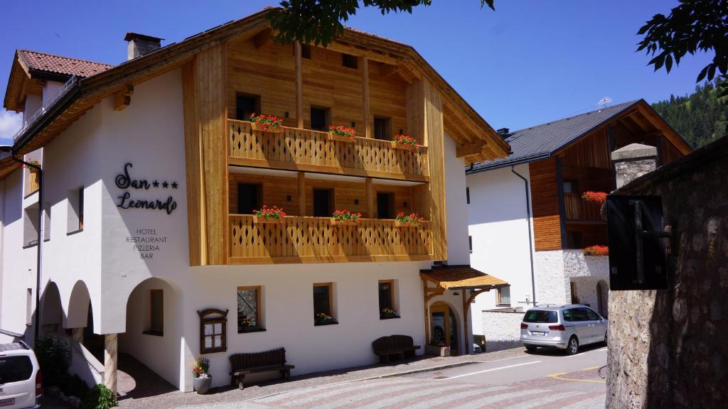 a building with a balcony with flowers on it at Hotel San Leonardo in Badia