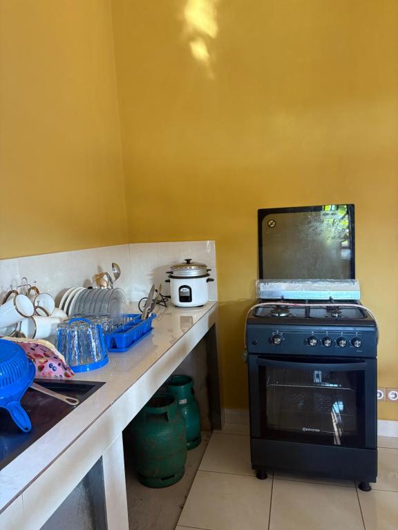 a kitchen with a stove and a counter top at Villa Donia Nosy be in Nosy Be