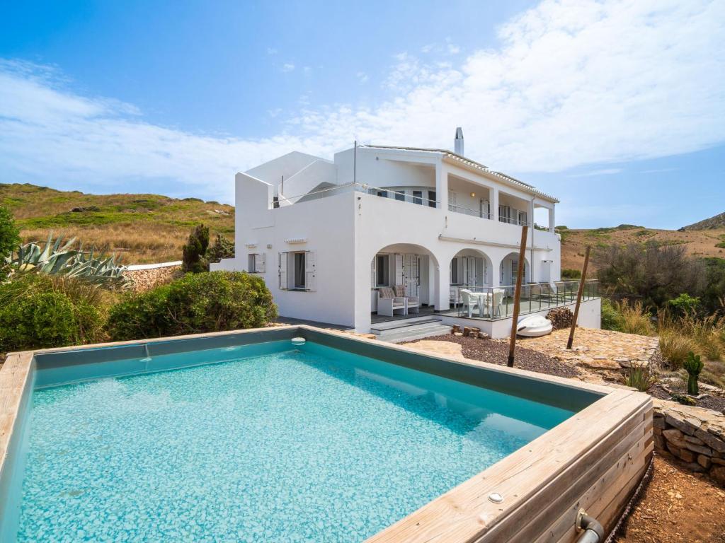 a villa with a swimming pool in front of a house at Villa Sa Blanca by Interhome in Es Mercadal
