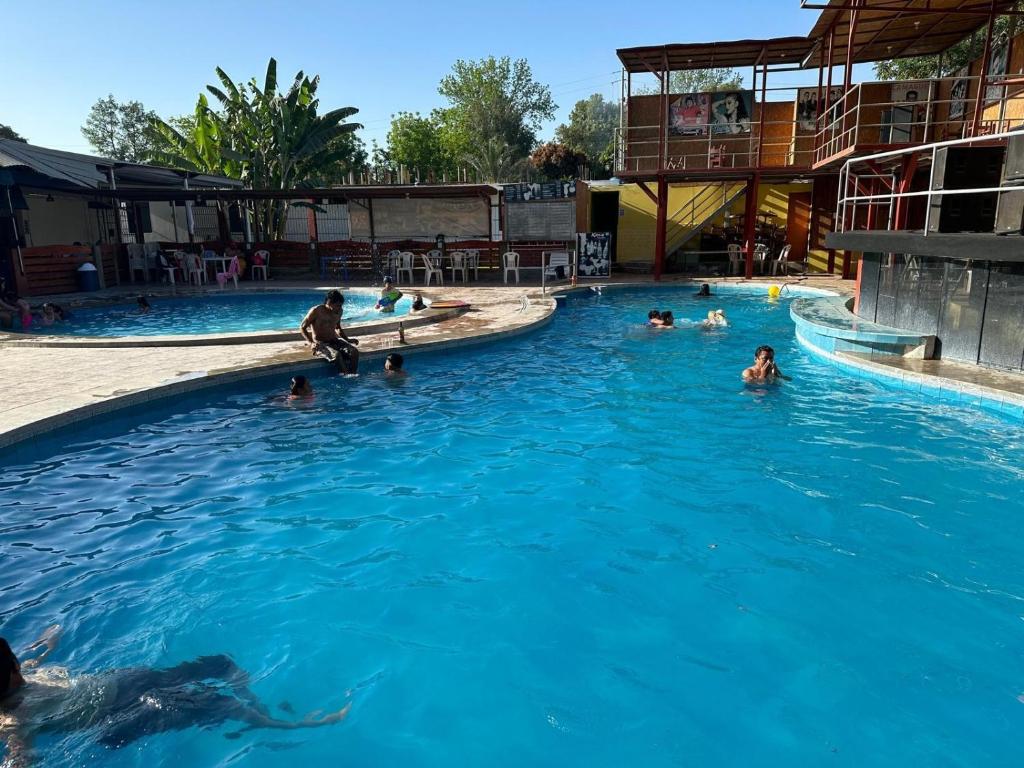 a group of people swimming in a swimming pool at Keylas Hotel in Ica