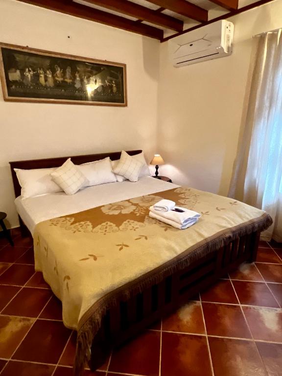 a bedroom with a bed with a towel on it at Haritham Heritage Villa - Rooms in Vadakkāncheri