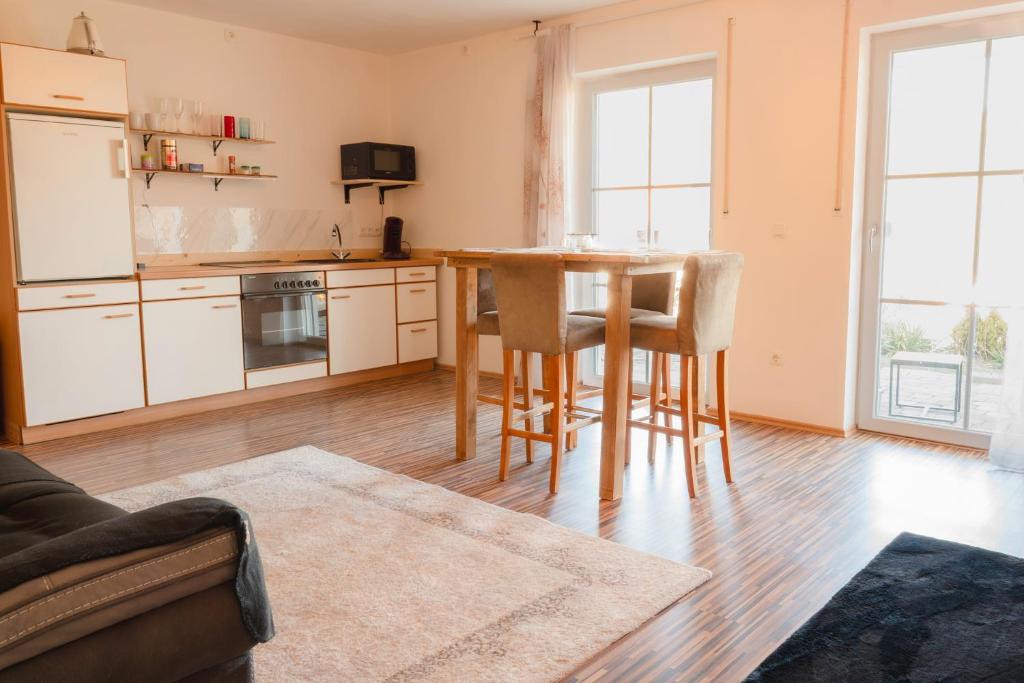 a kitchen with a table and chairs in a room at FeWo Böhaming in Schaufling