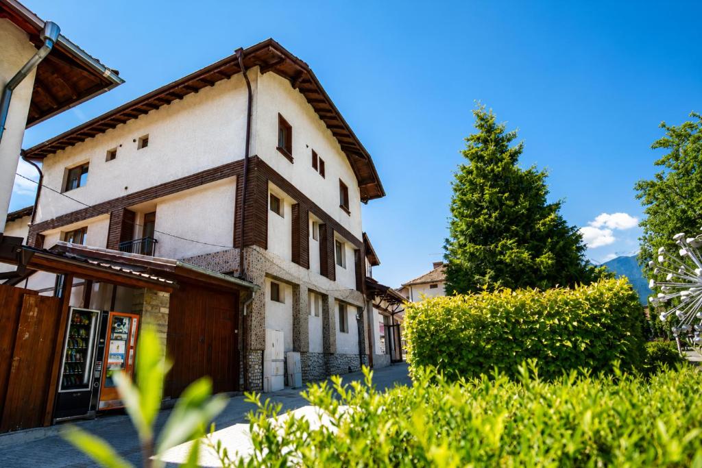 a building with a tree in front of it at Monte Vista in Bansko