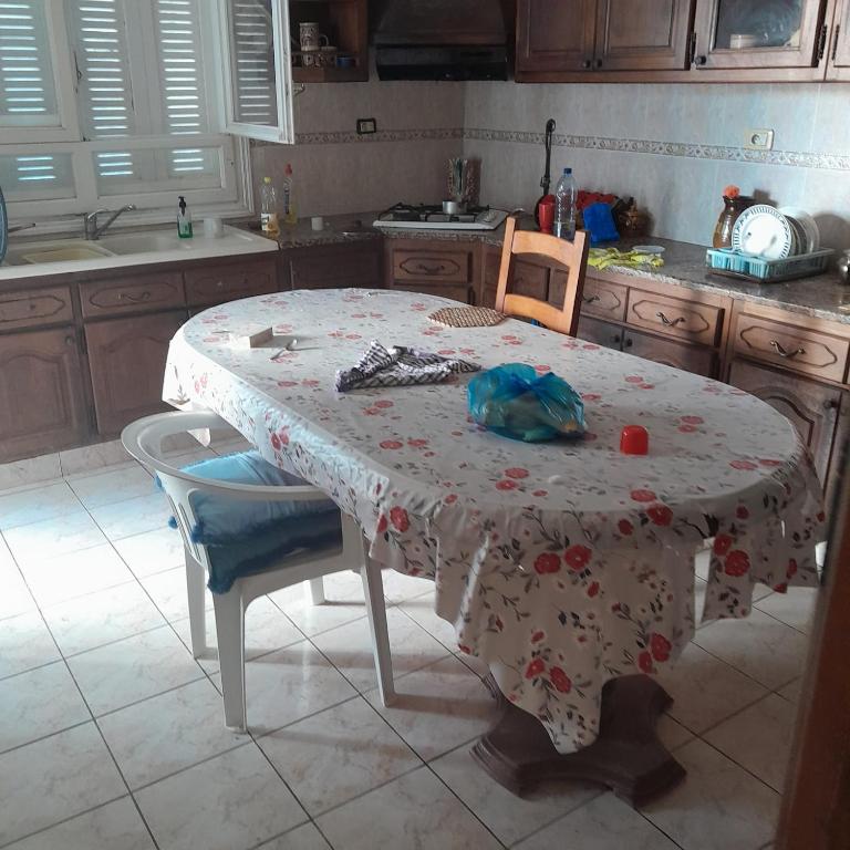 a kitchen with a table with a table cloth on it at Grande maison de vacances 250m2 in Rejiche