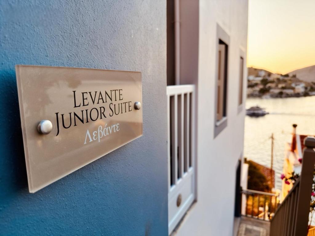 a sign on the side of a room with a window at Symi Aerides Suites in Symi