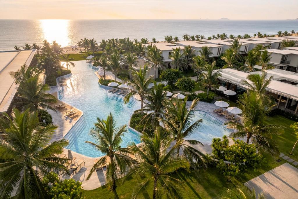an aerial view of a resort with a pool and palm trees at The Ocean Resort by Fusion Quy Nhon in Quy Nhon