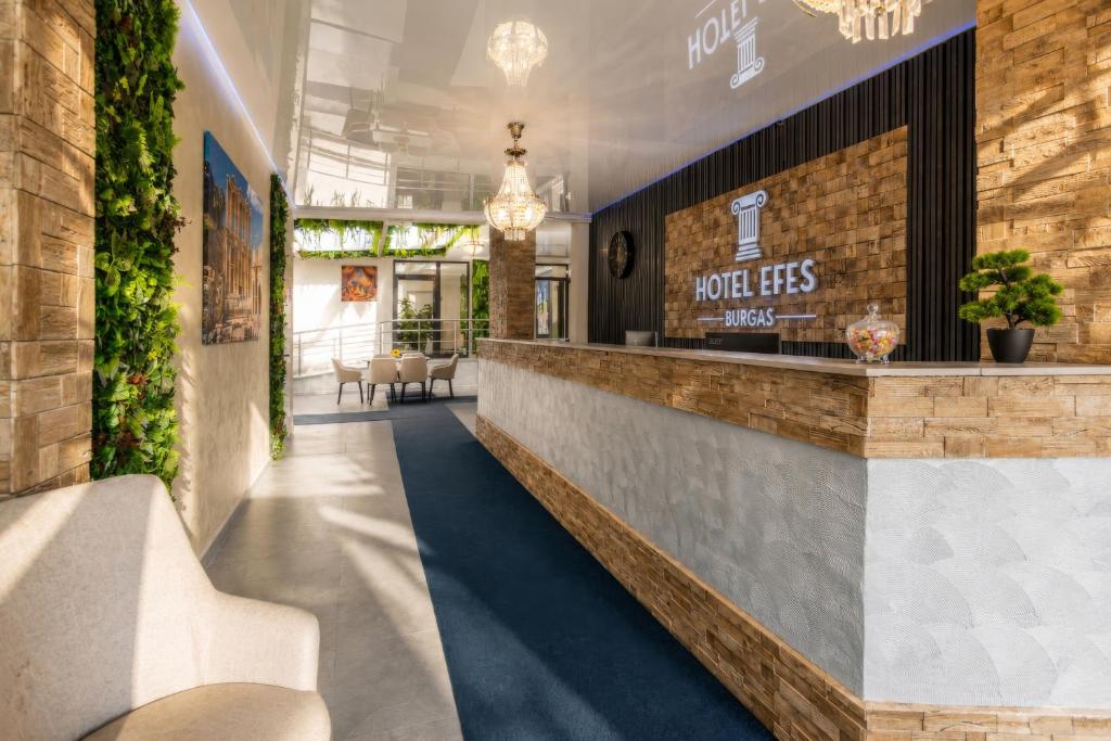 a lobby of a hotel with a reception counter at Хотел EFES in Burgas