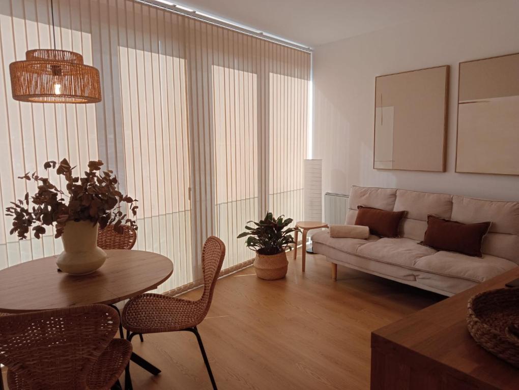 a living room with a couch and a table at Casa Tome A Teixeira - Ribeira Sacra in Teixeira
