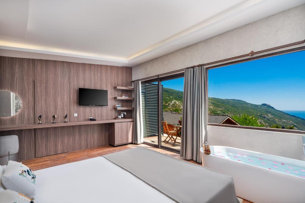 a bedroom with a tub and a large window at Turquoise Retreat Spa & Wellness in Kaş