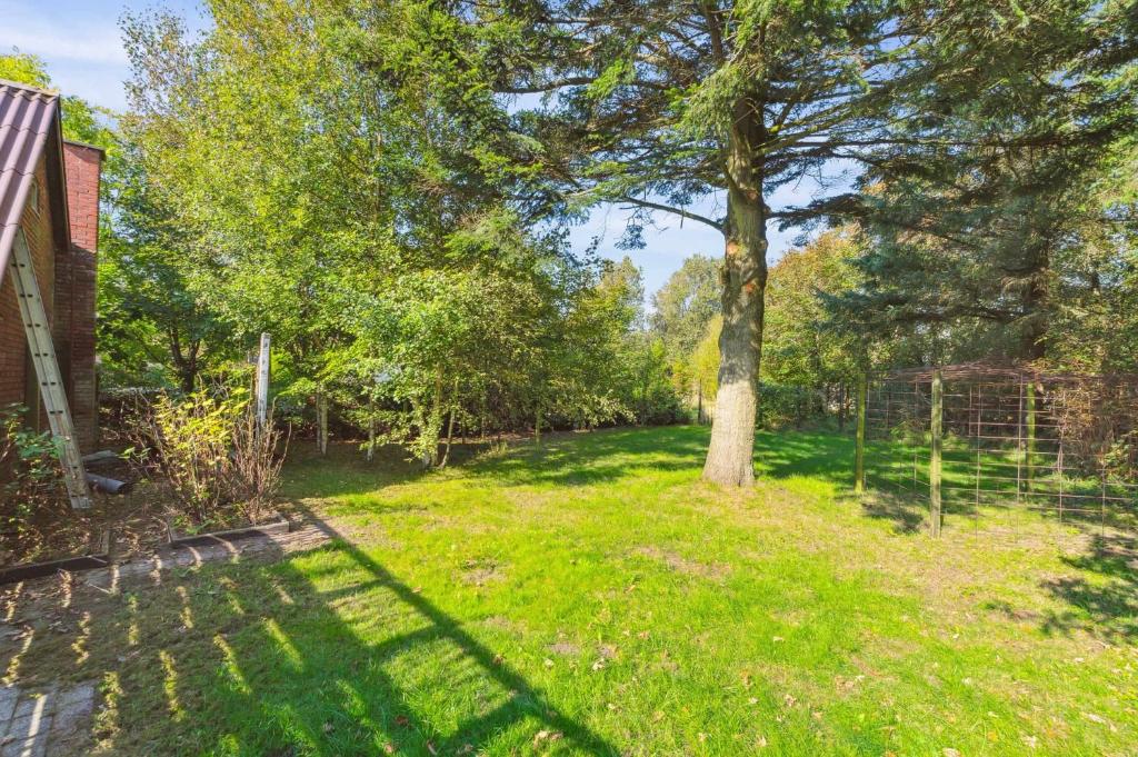 a yard with a tree and a fence at Villa With Three Bedrooms in Vemb