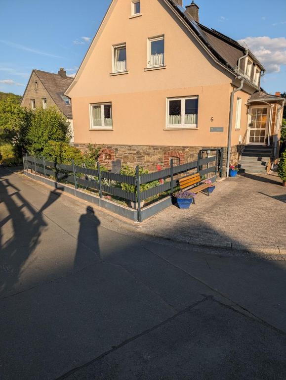 a shadow of a person in front of a house at Zum alten Schusterhaus in Bad Endbach