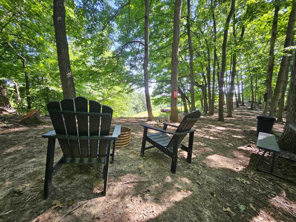 two chairs and a table in the woods at The Hocking Hills Store Campsite #2 in Logan