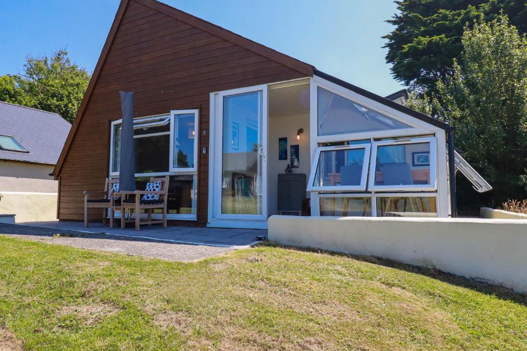 a house with a large sliding glass door at Coombe Lodge No 9 in Bude