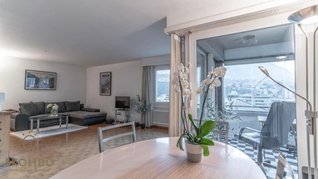 a living room with a couch and a table at Apartment house Lötschberg in Naters