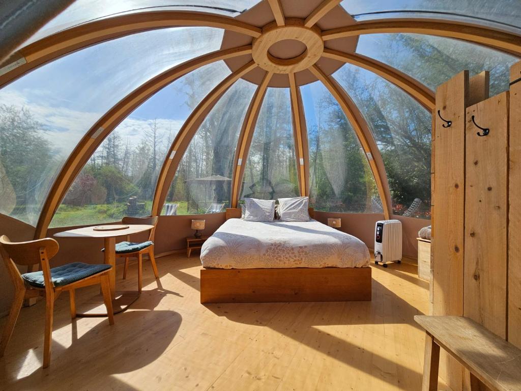 a room with a bed and a large window at Bulle insolite Wigwam in Aulnay-sur-Iton