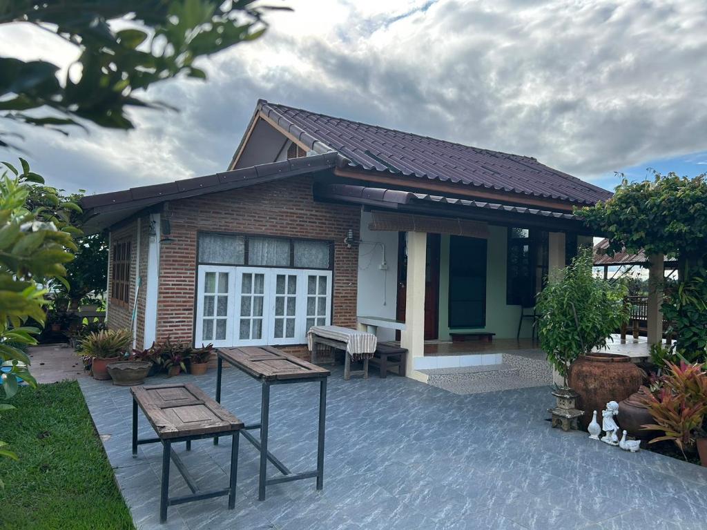 a house with a table and benches in front of it at Darins House in Nan