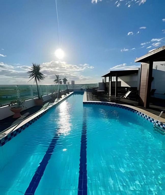 a large blue swimming pool on top of a building at WestFlat - Barreto 206 in Mossoró