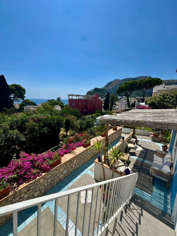 a balcony of a building with flowers and plants at Capri Joy Apartments in Capri