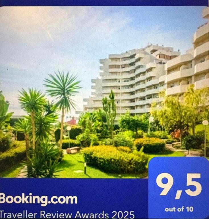 a blue sign with a building in the background at Benalbeach Zafiro by C&N in Benalmádena