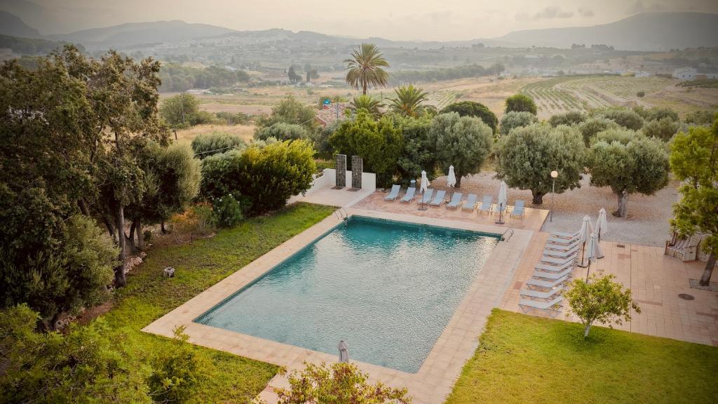 an overhead view of a swimming pool with chairs and trees at Finca Olivar Country Boutique Hotel in Benissa