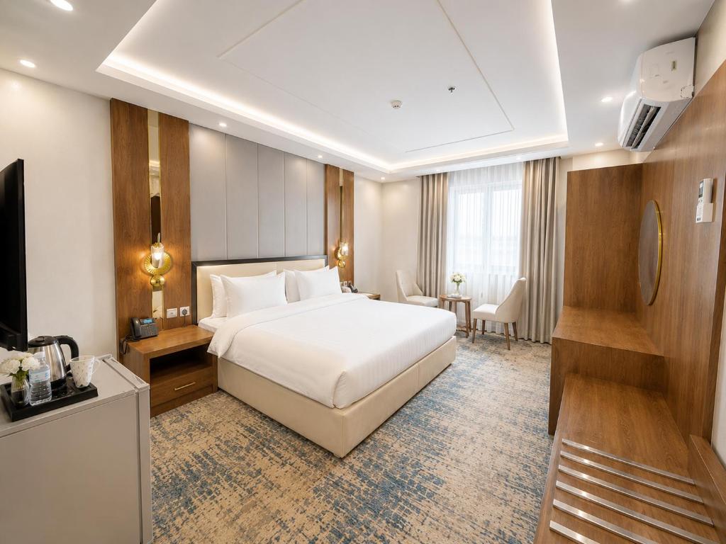 a hotel room with a bed and a television at Jwana in Riyadh