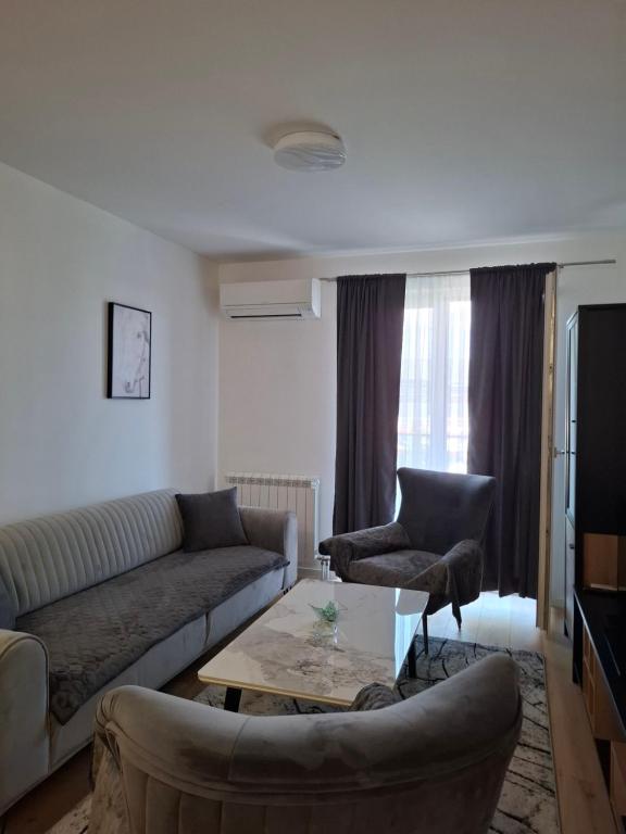 a living room with a couch and a table at Apartman THE VIEW in Vranješ